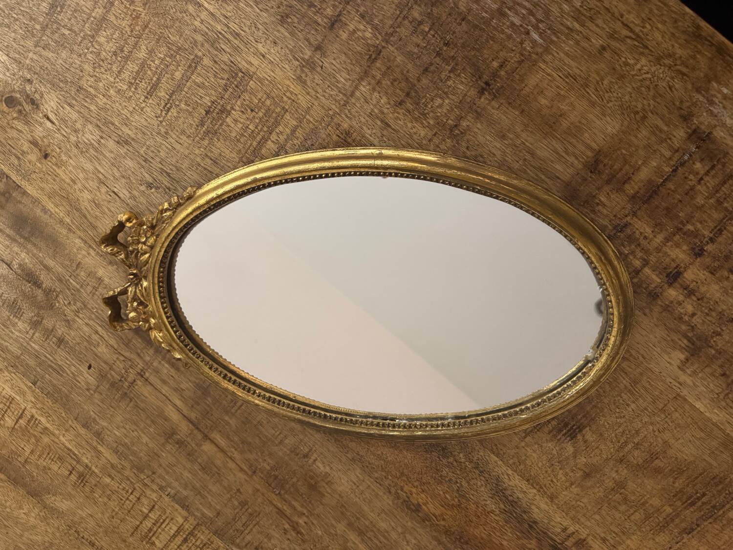 Oval gold knot mirror