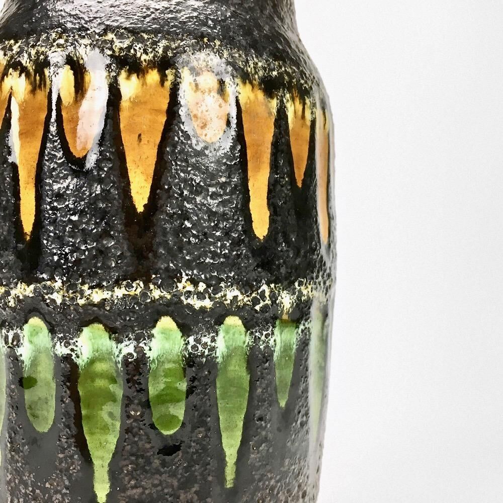 "Fat Lava" vase black background and colorful enamelled drippings