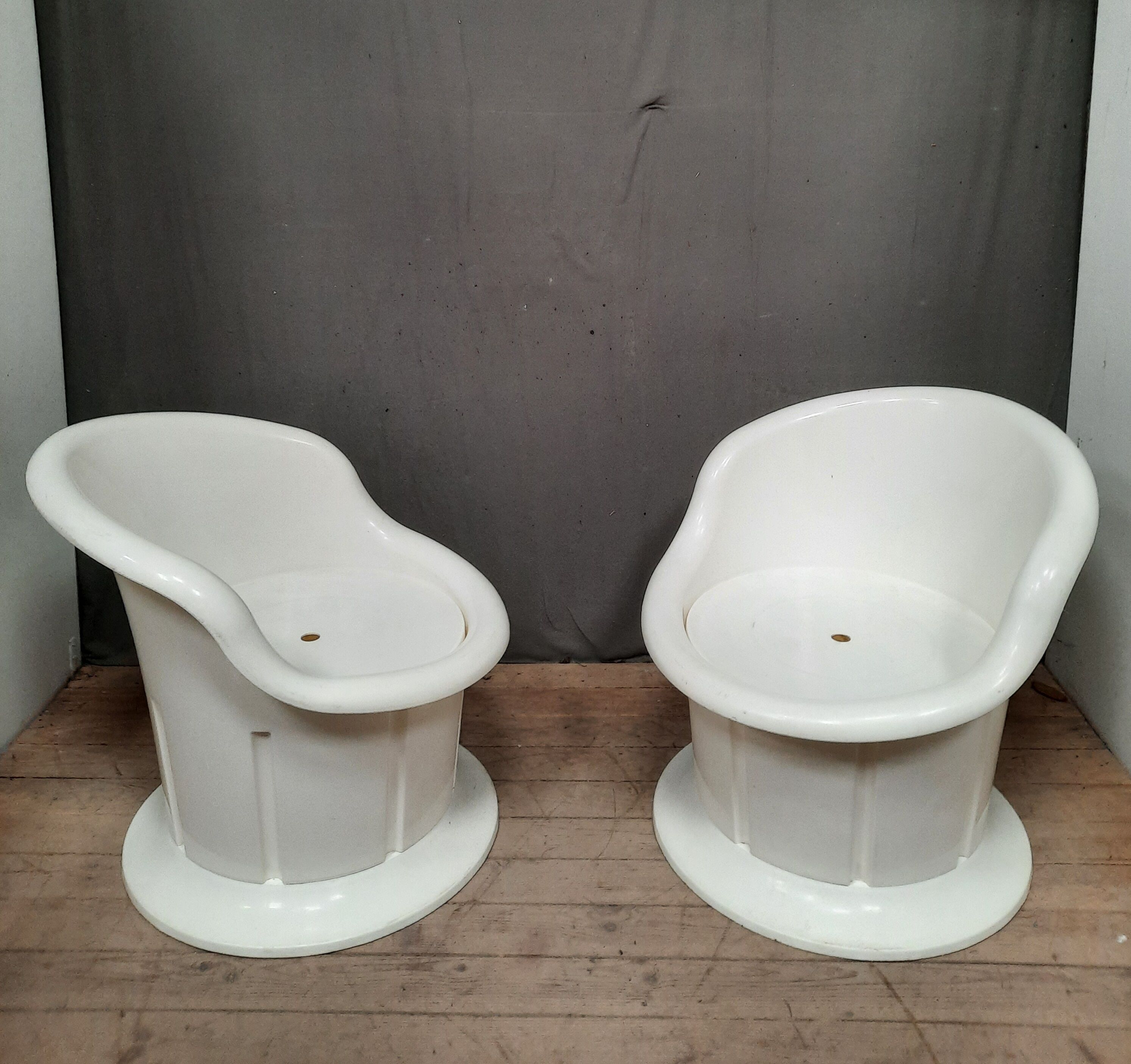 Pair of white plastic armchairs