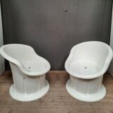 Pair of white plastic armchairs