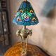 bronze lamp with a goat's head from the 19th century and a stained glass lampshade soldered with lead