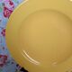 Old round plate in yellow faïence