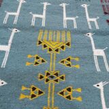 Blue carpet with gazelle patterns woven by hand