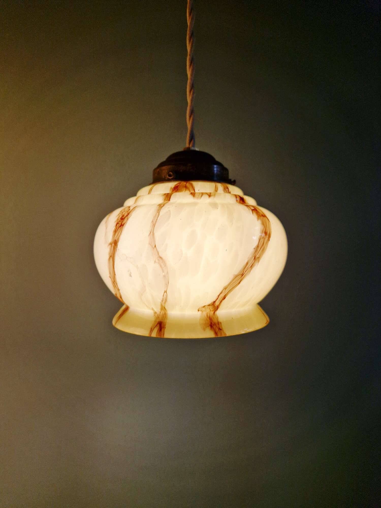 Trio of Art Deco marbled opaline pendant lights, 1920-30