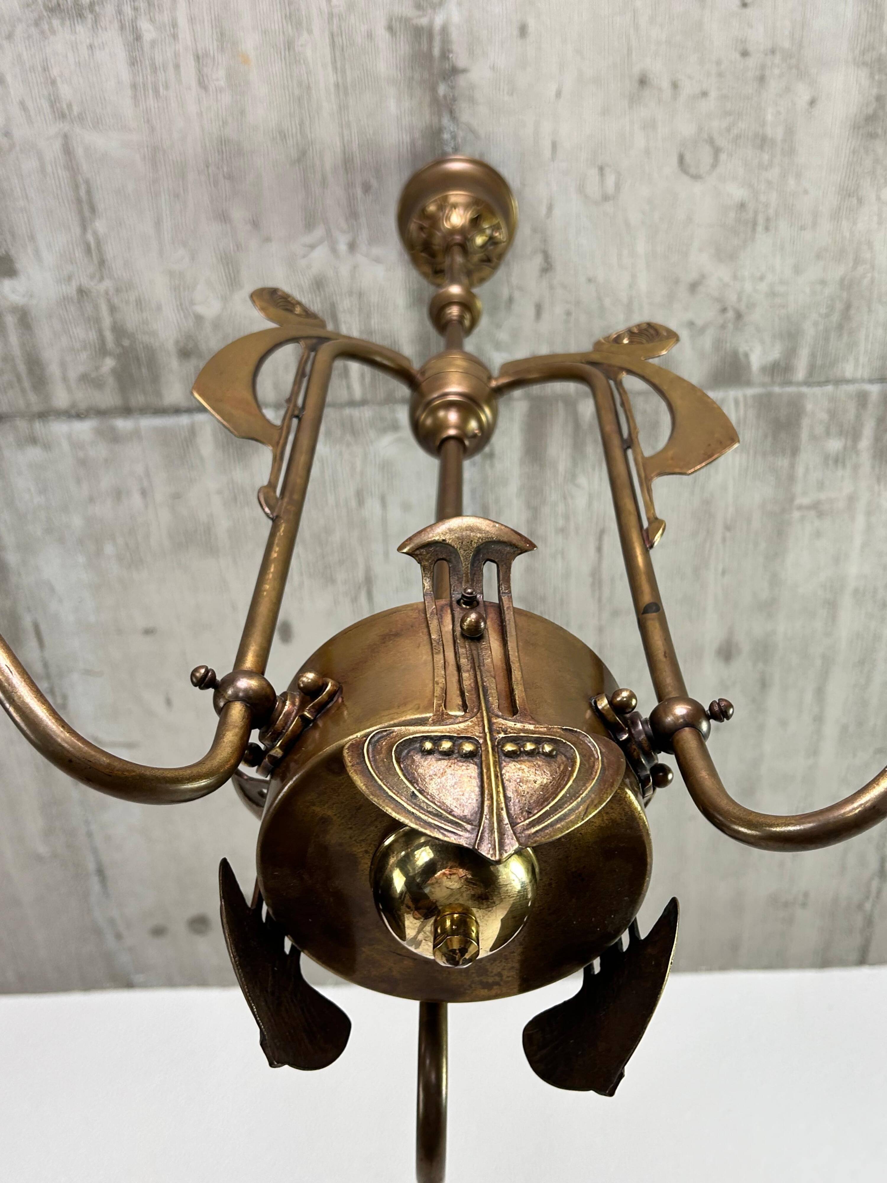 Art Nouveau chandelier with three arms and opalescent iridescent glass.