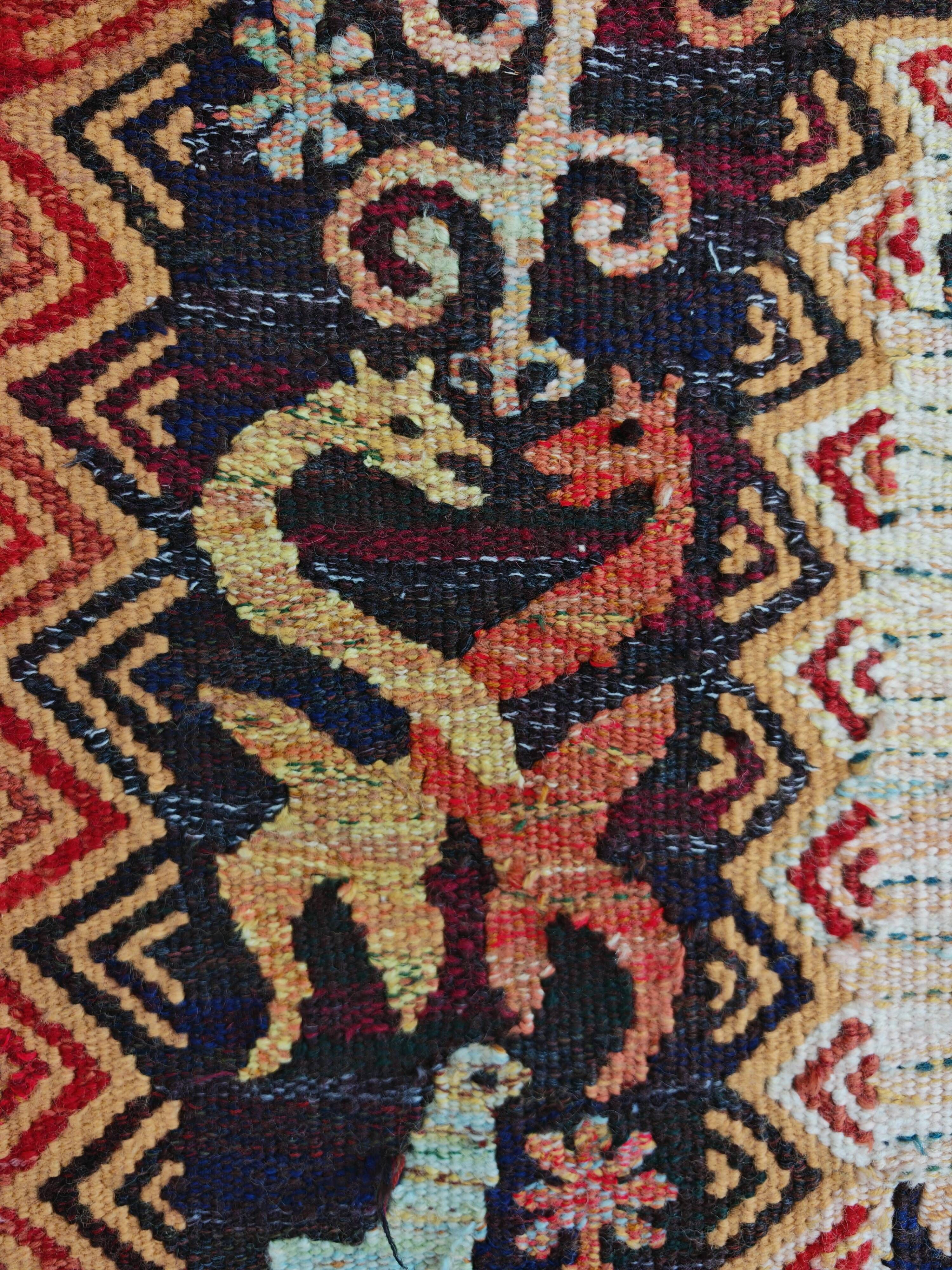 Vintage handwoven tapestry with a folk scene and archaic Slavic writing.