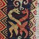 Vintage handwoven tapestry with a folk scene and archaic Slavic writing.