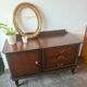 Dark wood sideboard with brass finishes and compass feet