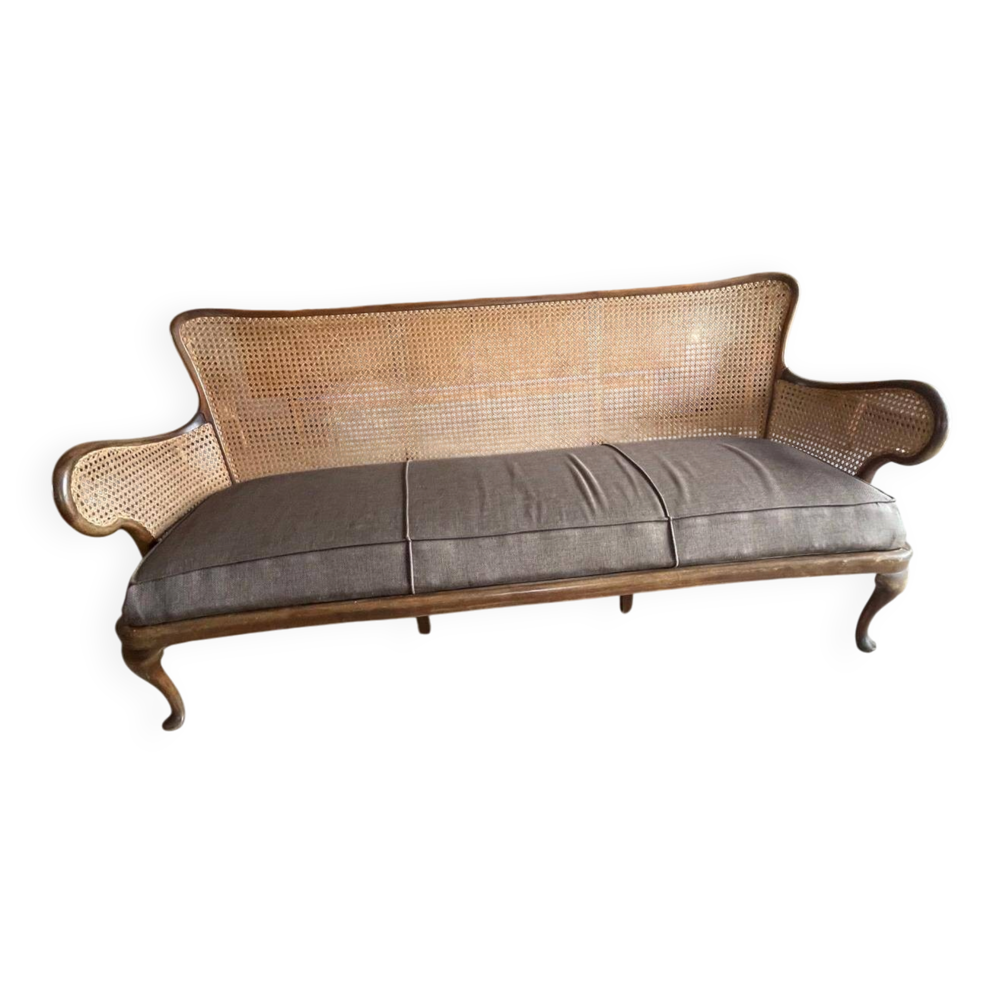 Sofa with backrest and cane armrests