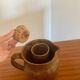 Large antique brown glazed stoneware jug with cork stopper.
