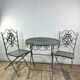 Patinated green folding wrought iron garden set with 1 table + 2 chairs.