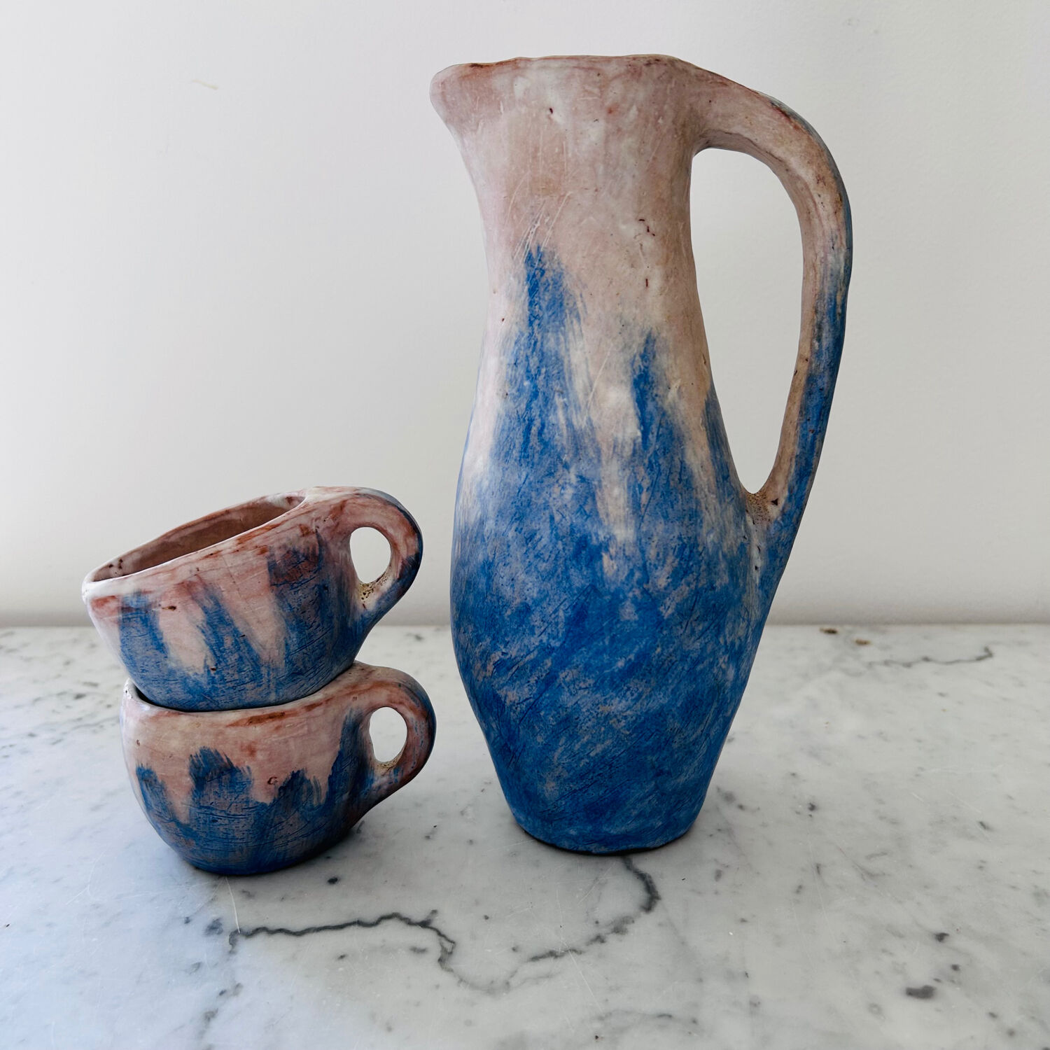Set of artisanal pitcher and weathered cups