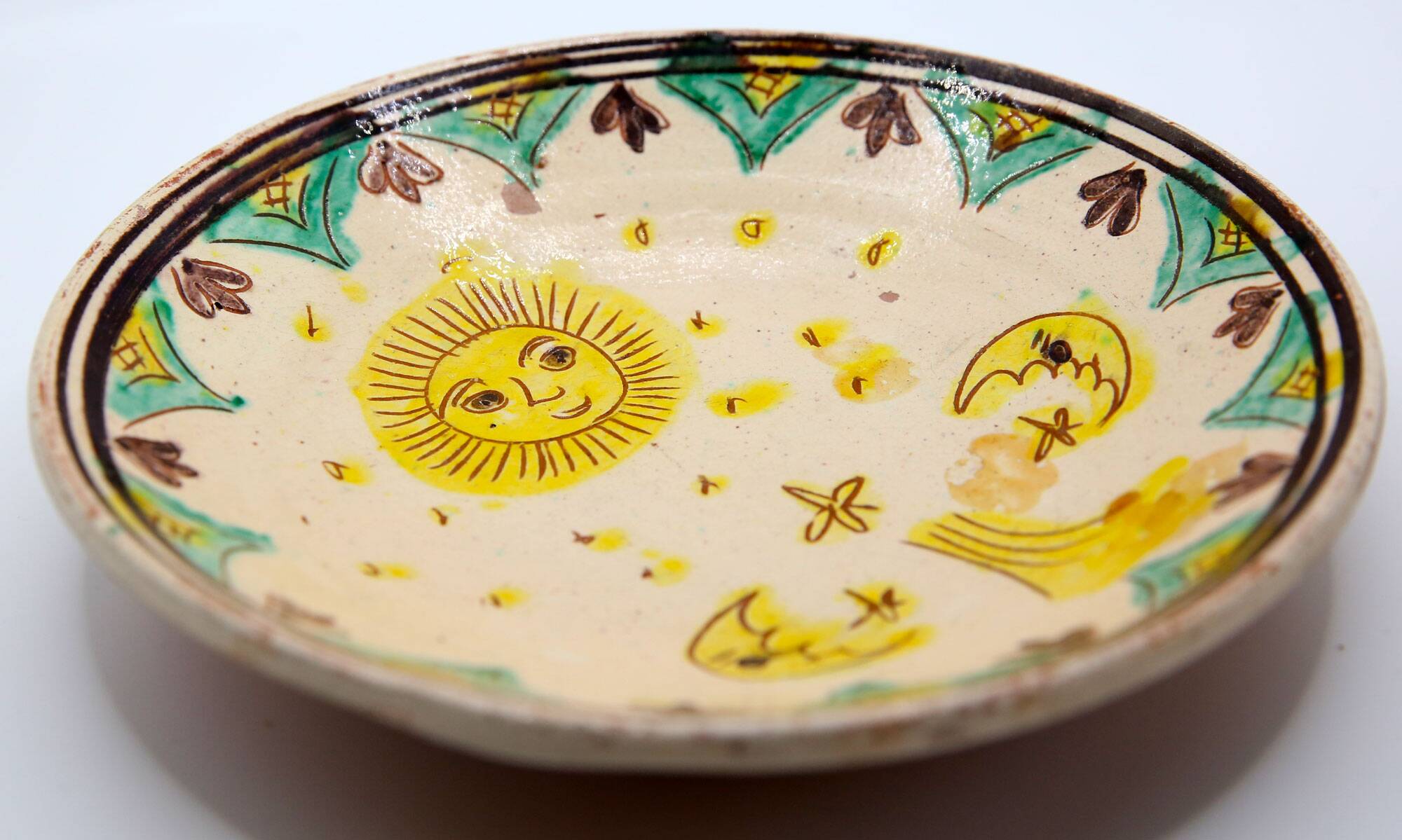 Handmade plate with moon and sun in Romania