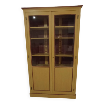 Old glass cabinet in yellow patinated wood