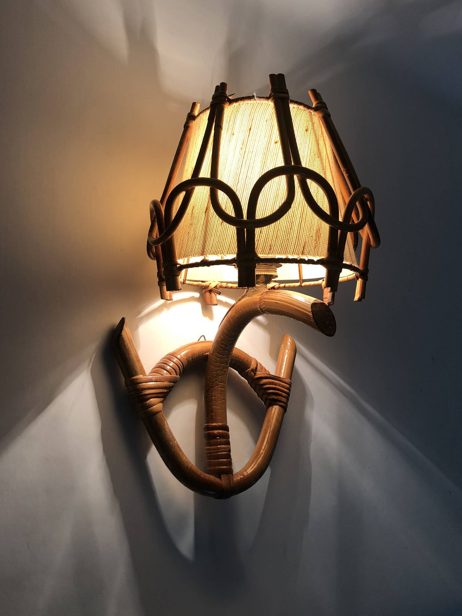 Louis Sognot rattan and bamboo wall light. 1950s