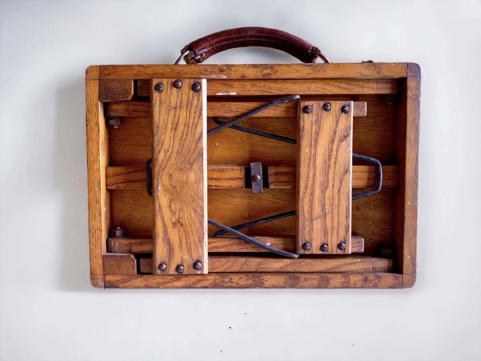 Old foldable fisherman's stool in wood and leather