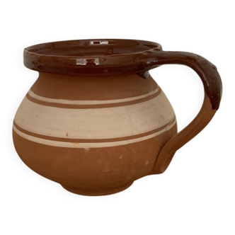 Hungarian folk ceramic pitcher in glossy brown and beige, traditional rounded pot.