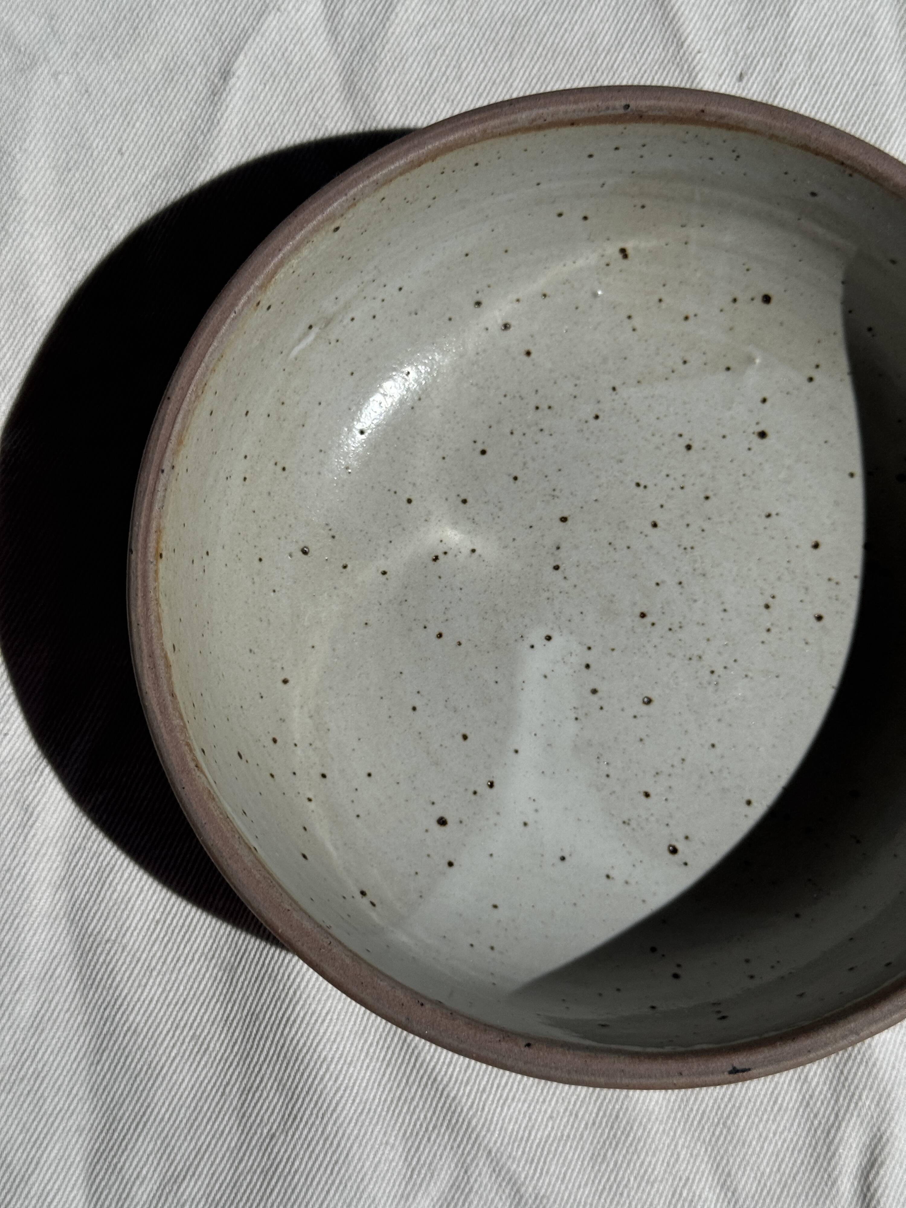 A speckled grey interior bowl with a matte brown exterior H5 D15