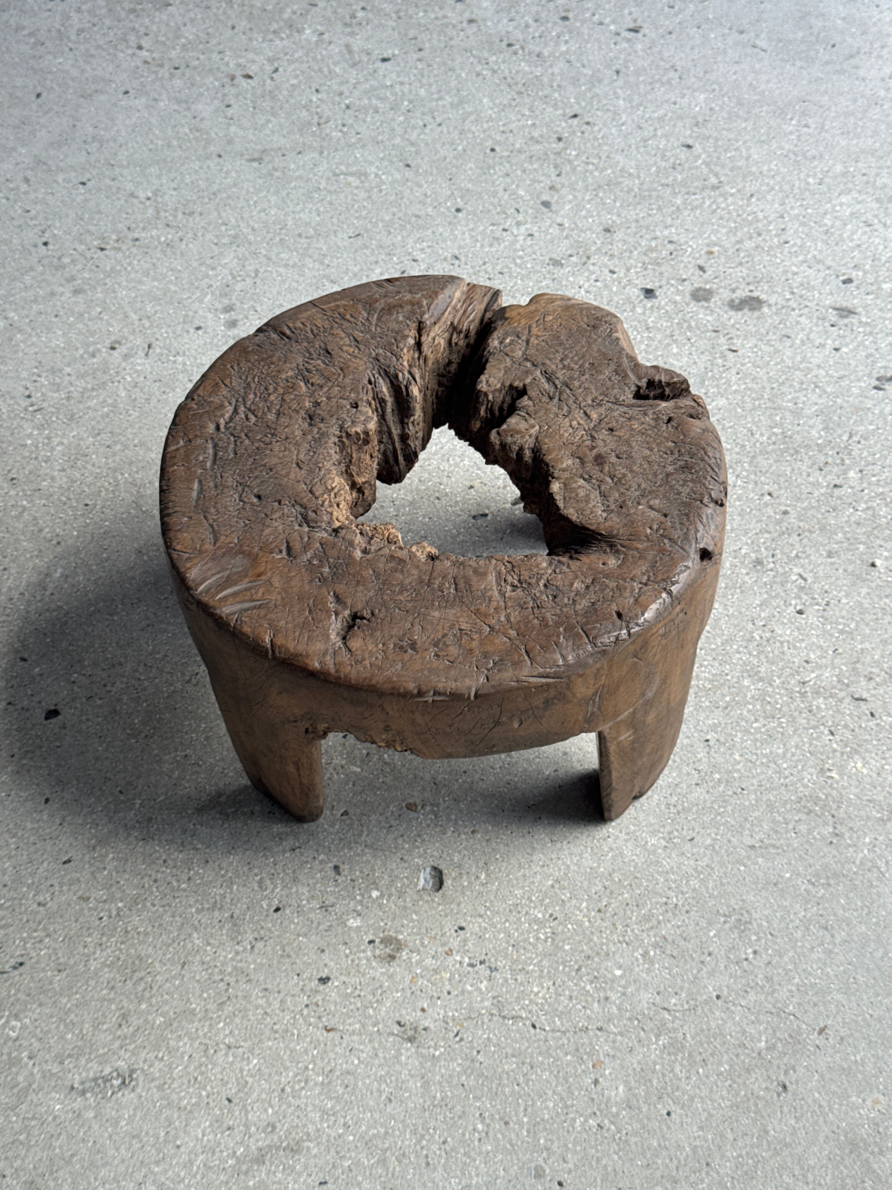 Small low circular four-legged stool in organic old teak with cut-out design H2
