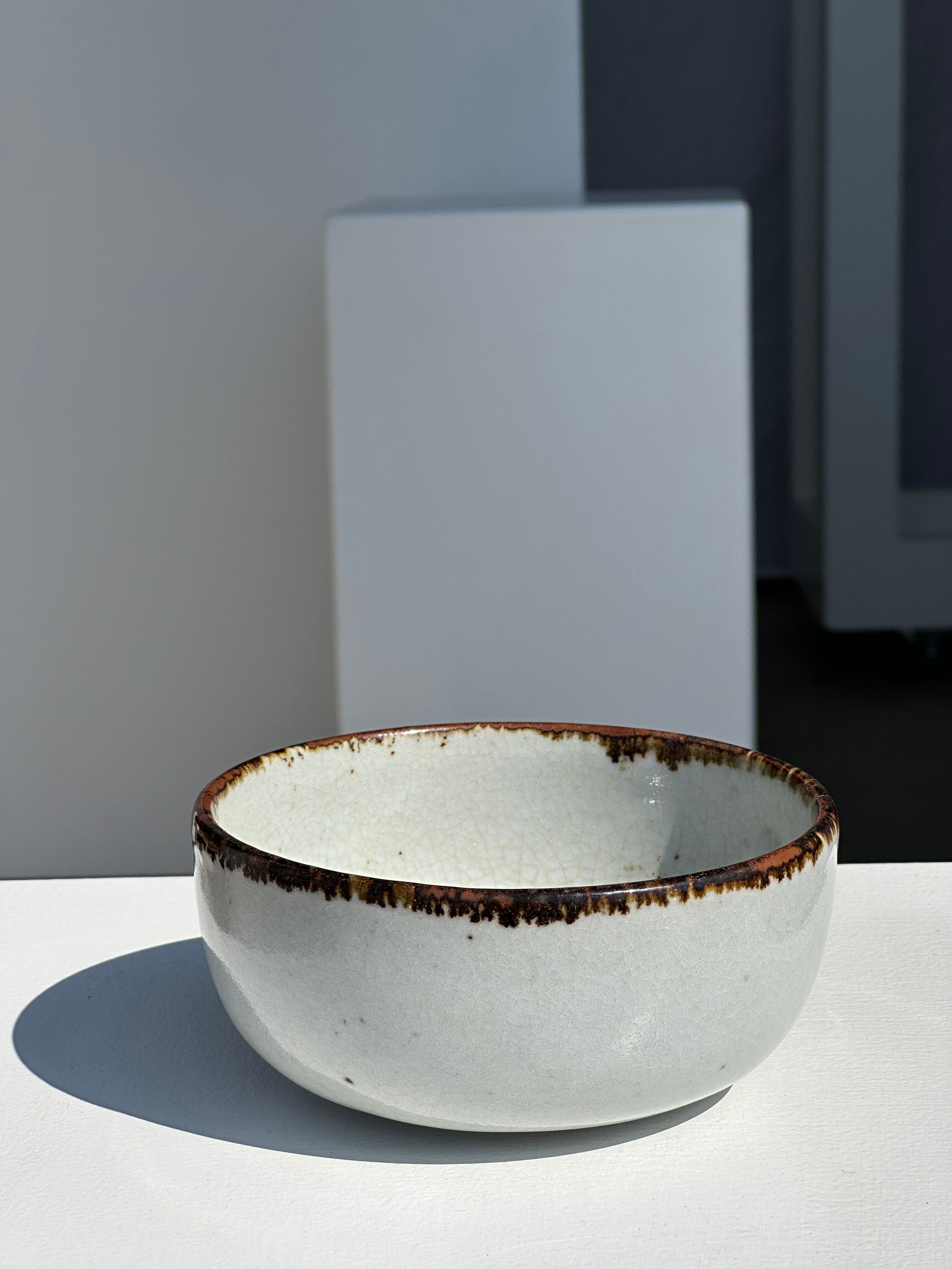Small white glazed ceramic bowl black edges