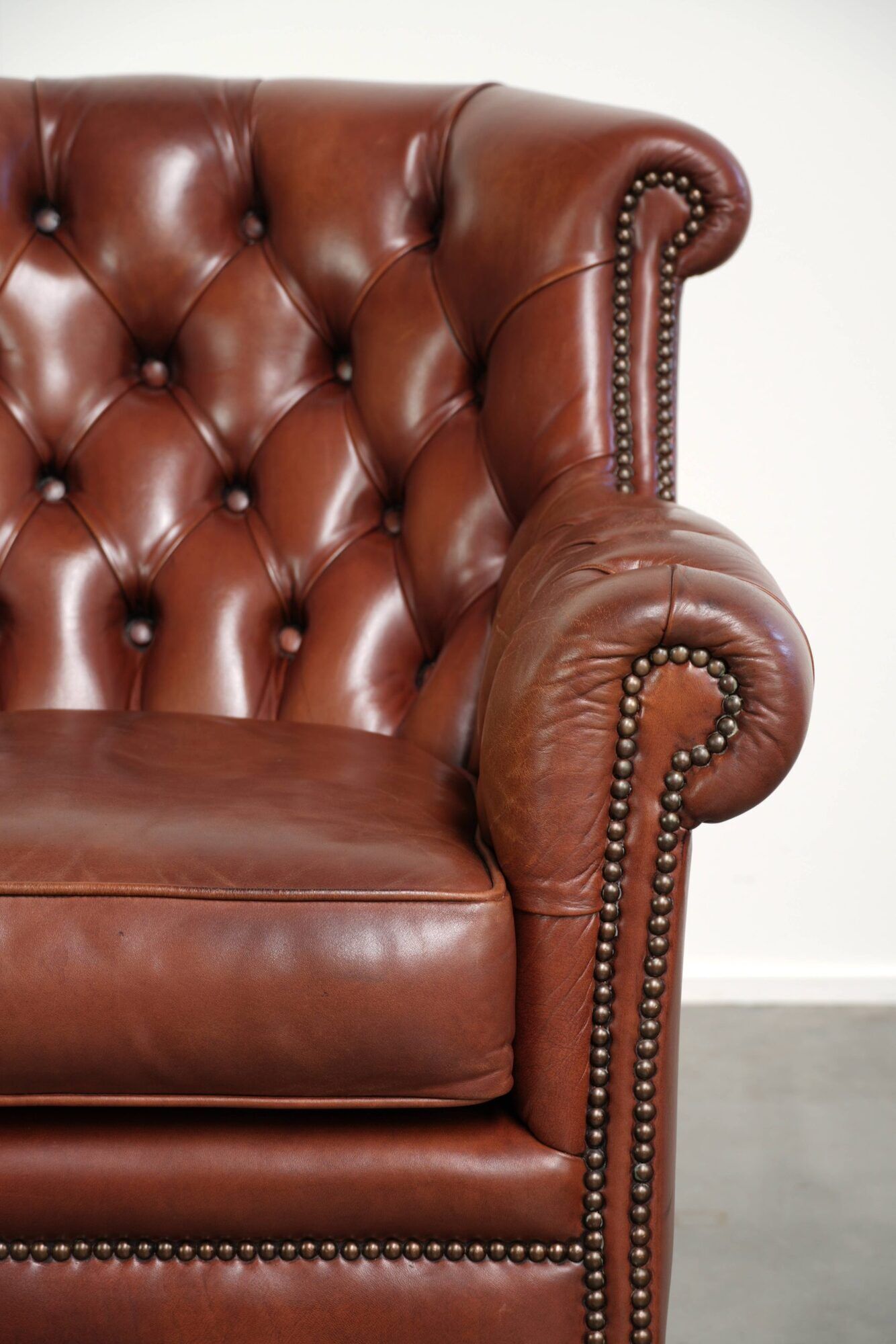 Cognac-coloured cow leather Chesterfield armchair in English style