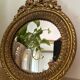Round golden convex mirror with mouldings - witch's mirror