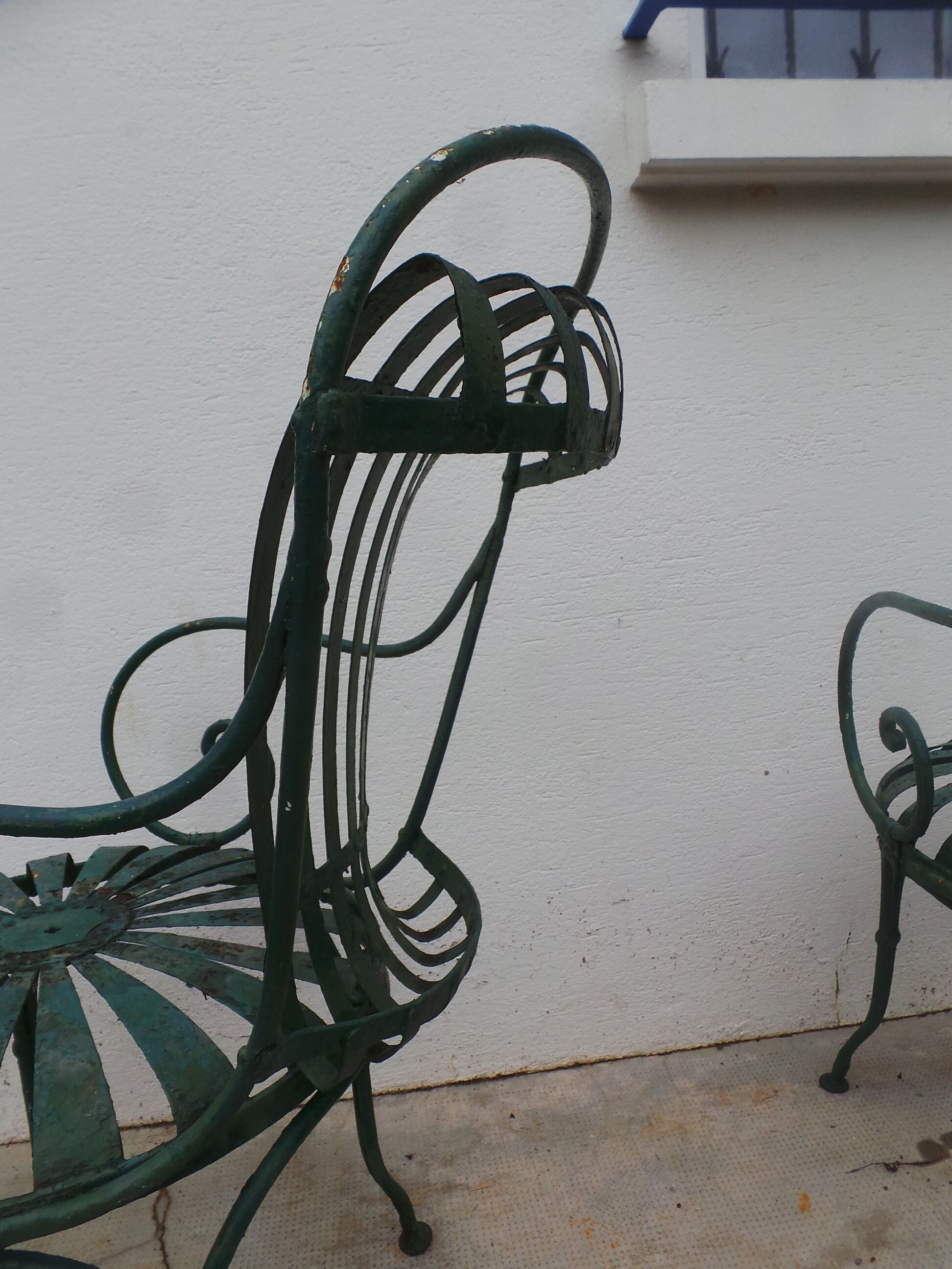 Pair of wrought iron garden chairs by François Carre