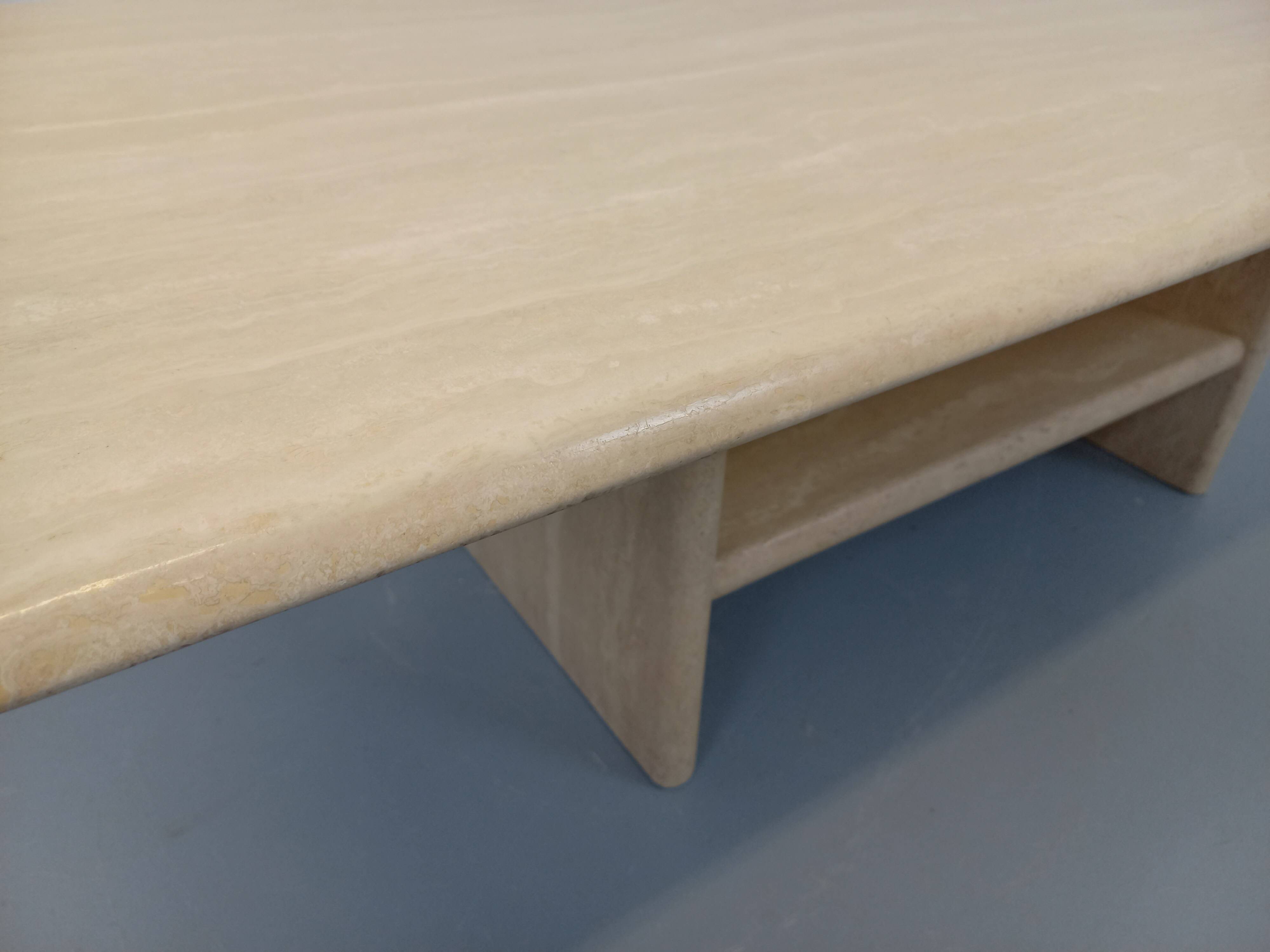 Vintage rectangular coffee table in travertine with magazine rack.