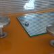 1950s coat rack with mirror, metal hooks, and glass shelf.