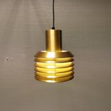 Hanging lamp in gold-colored aluminum with many layers of shades.