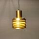Hanging lamp in gold-colored aluminum with many layers of shades.