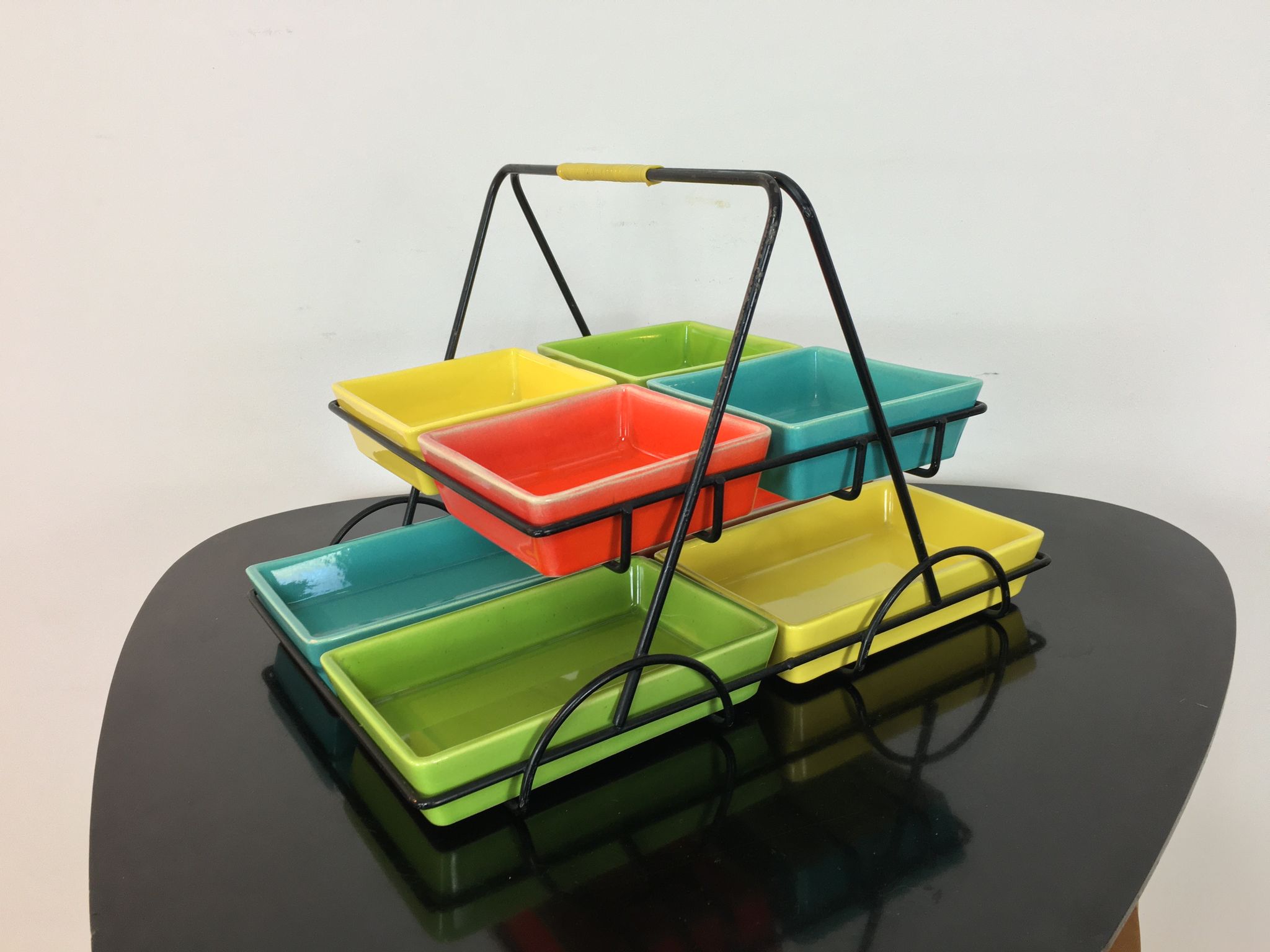 Black metal appetizer set with colorful ceramic ramekins