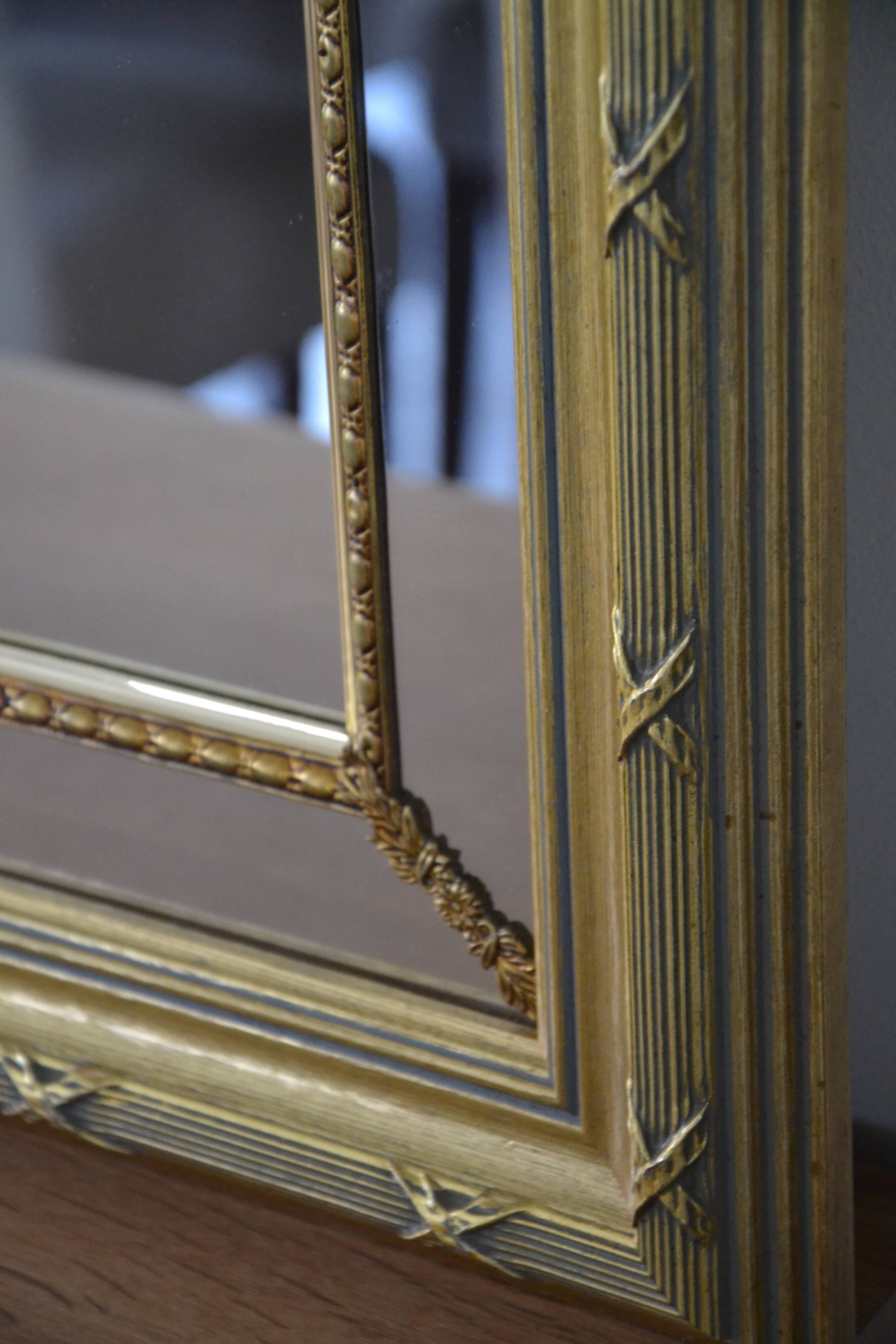 Large mirror with wooden gilded and carved frame.