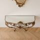 Golden wrought iron console and mirror in rococo style.
