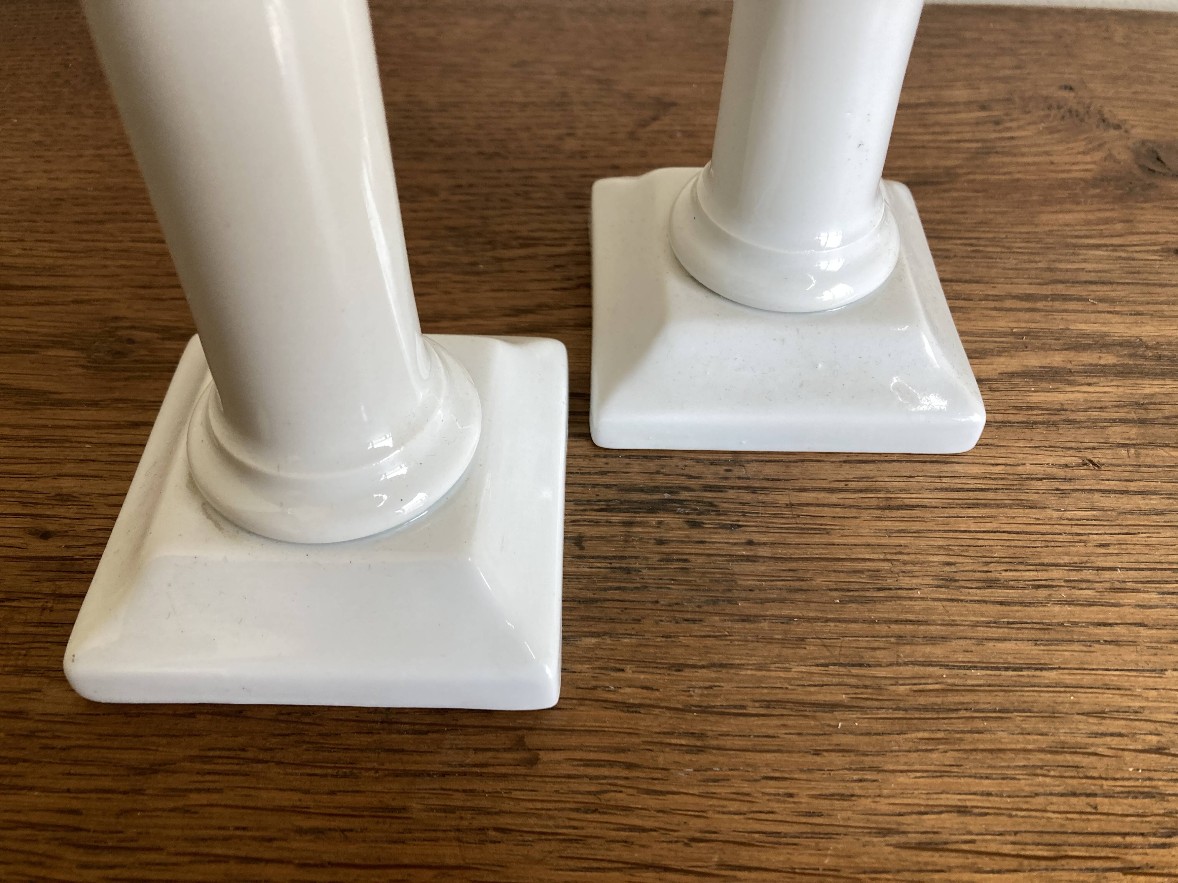 Pair of neo-classical Empire candlesticks from the late 19th century in white porcelain.
