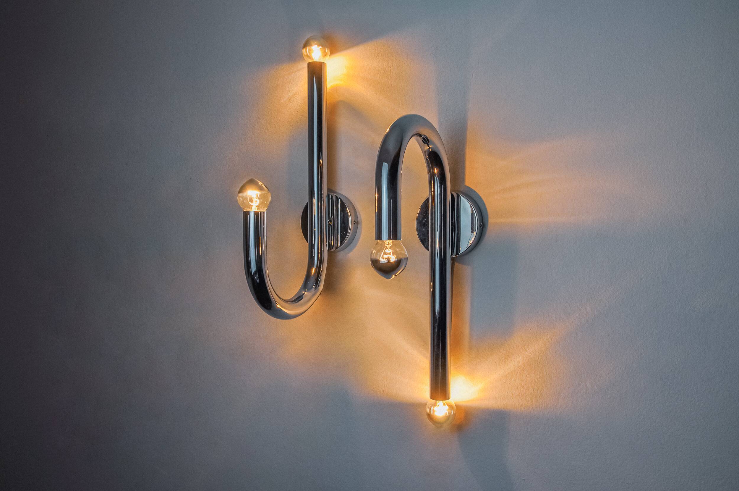 Pair of space-age tubular wall lights, chromed metal, Italy, 1970