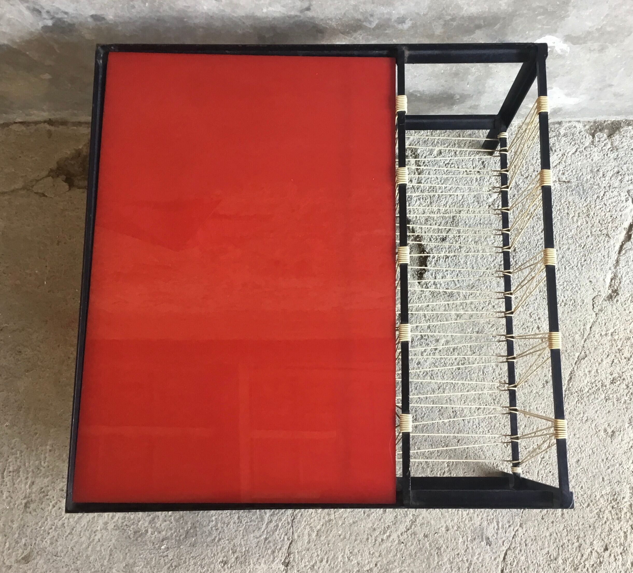 Modernist metal coffee table with a magazine rack in 1950s design.