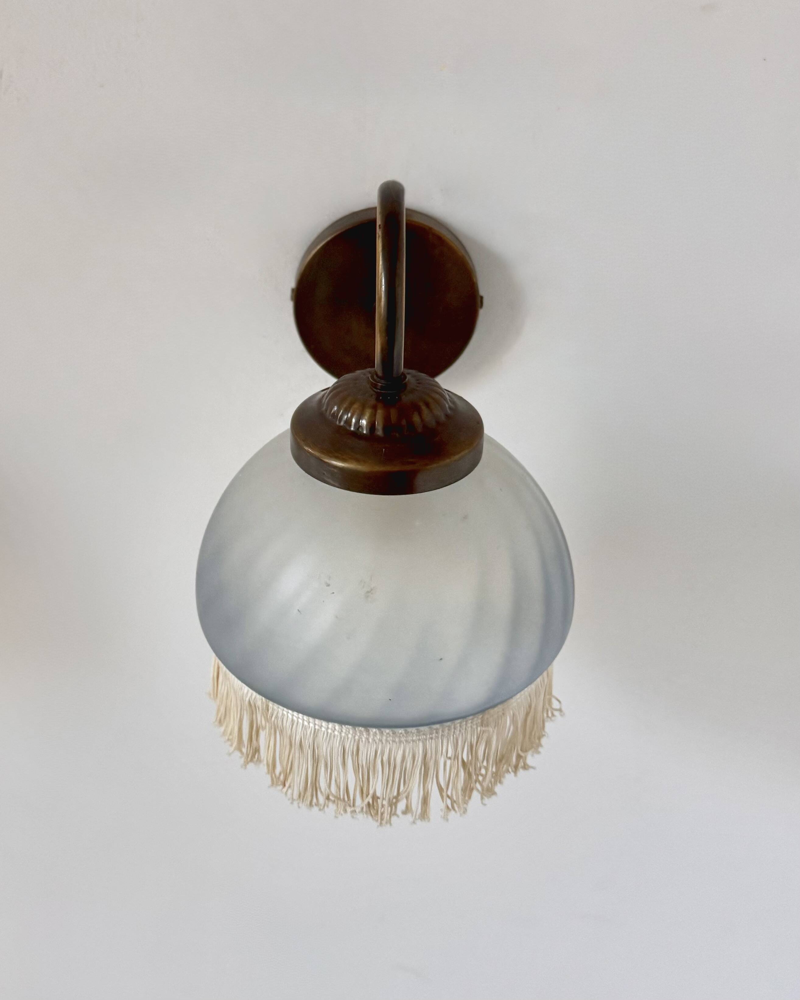 Pair of vintage wall lights in brass and blue-tinted glass, France 1970.