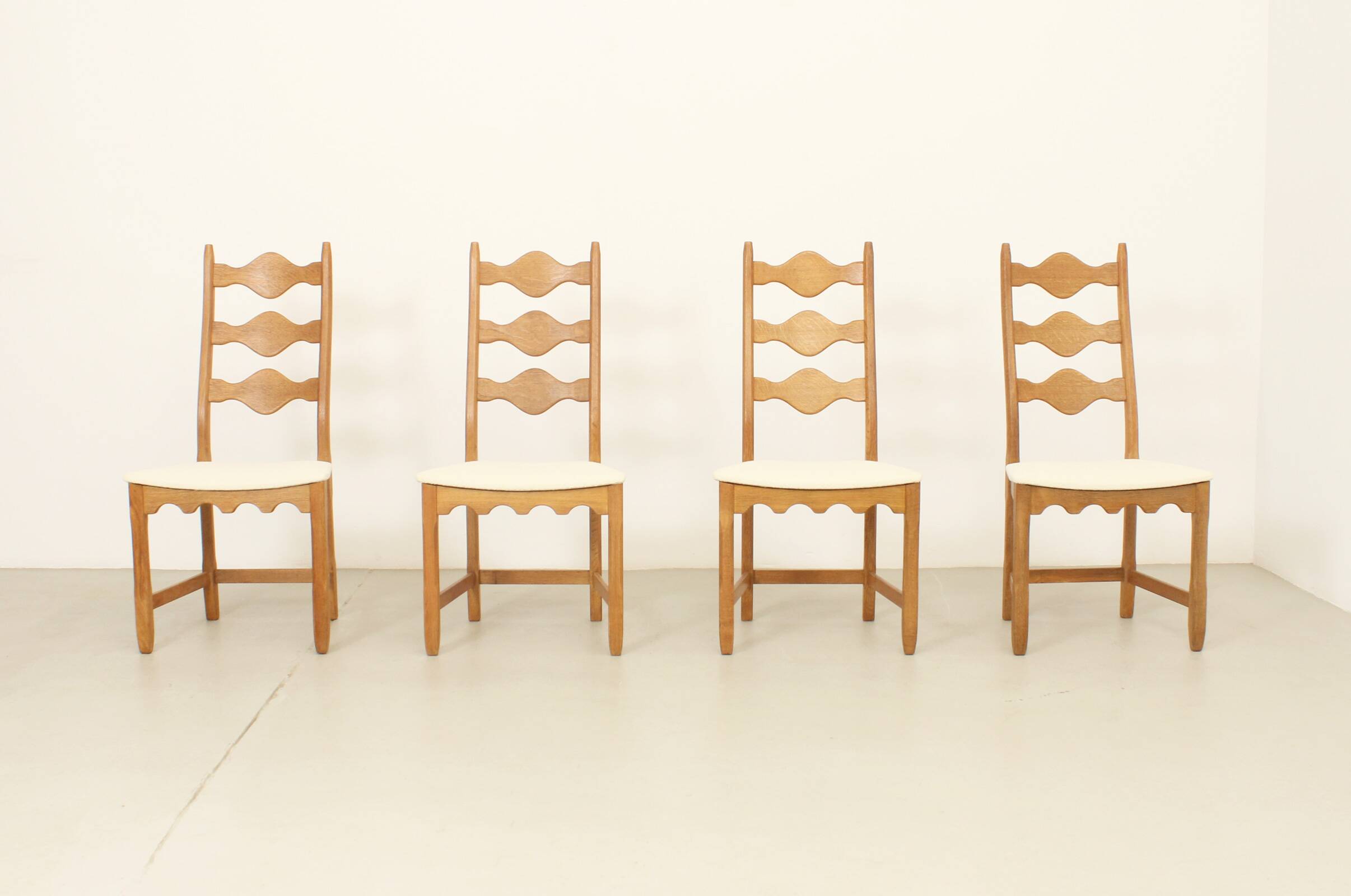 Four oak dining chairs by Henning Kjaernulf.