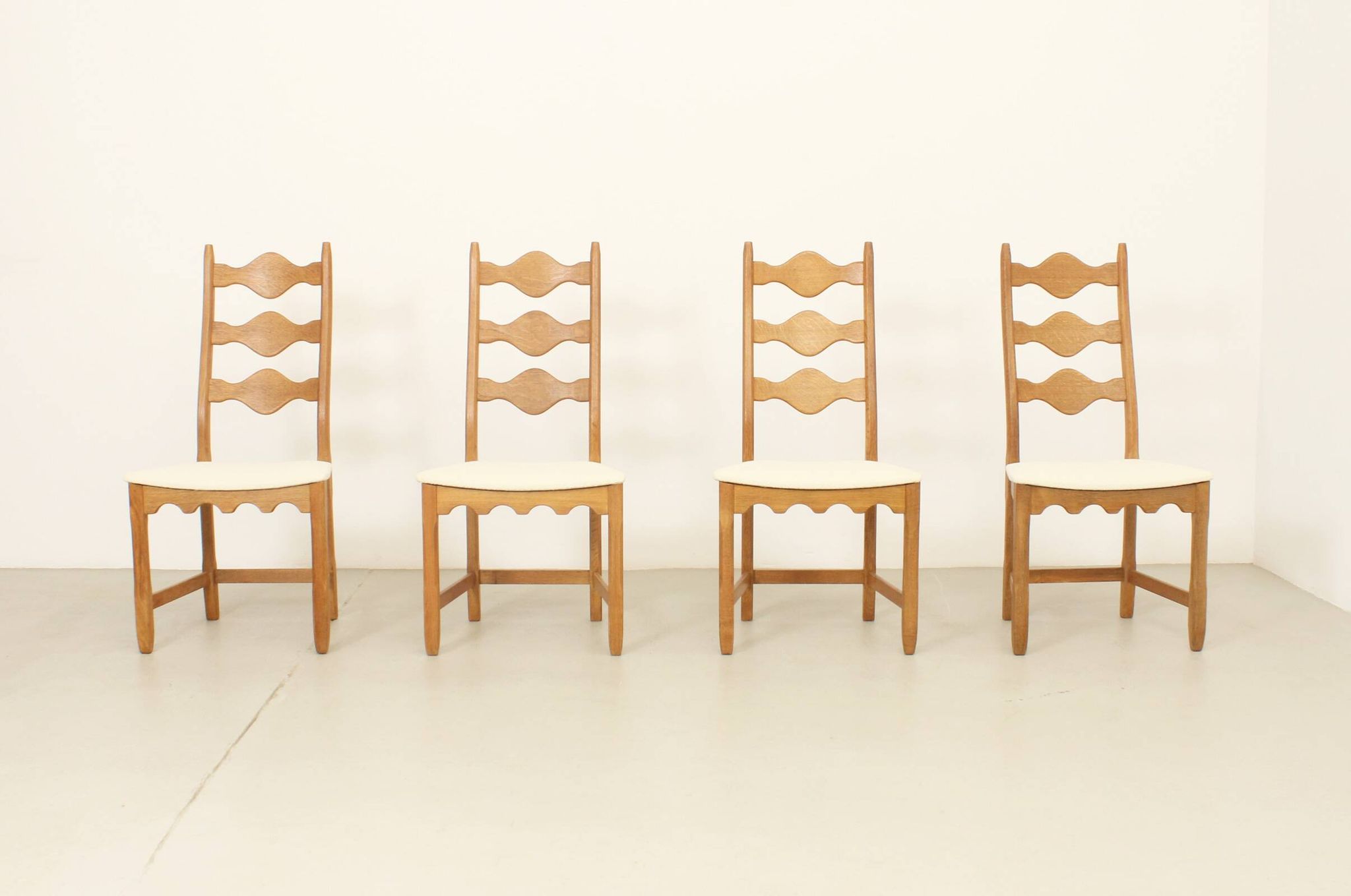 Four oak dining chairs by Henning Kjaernulf.