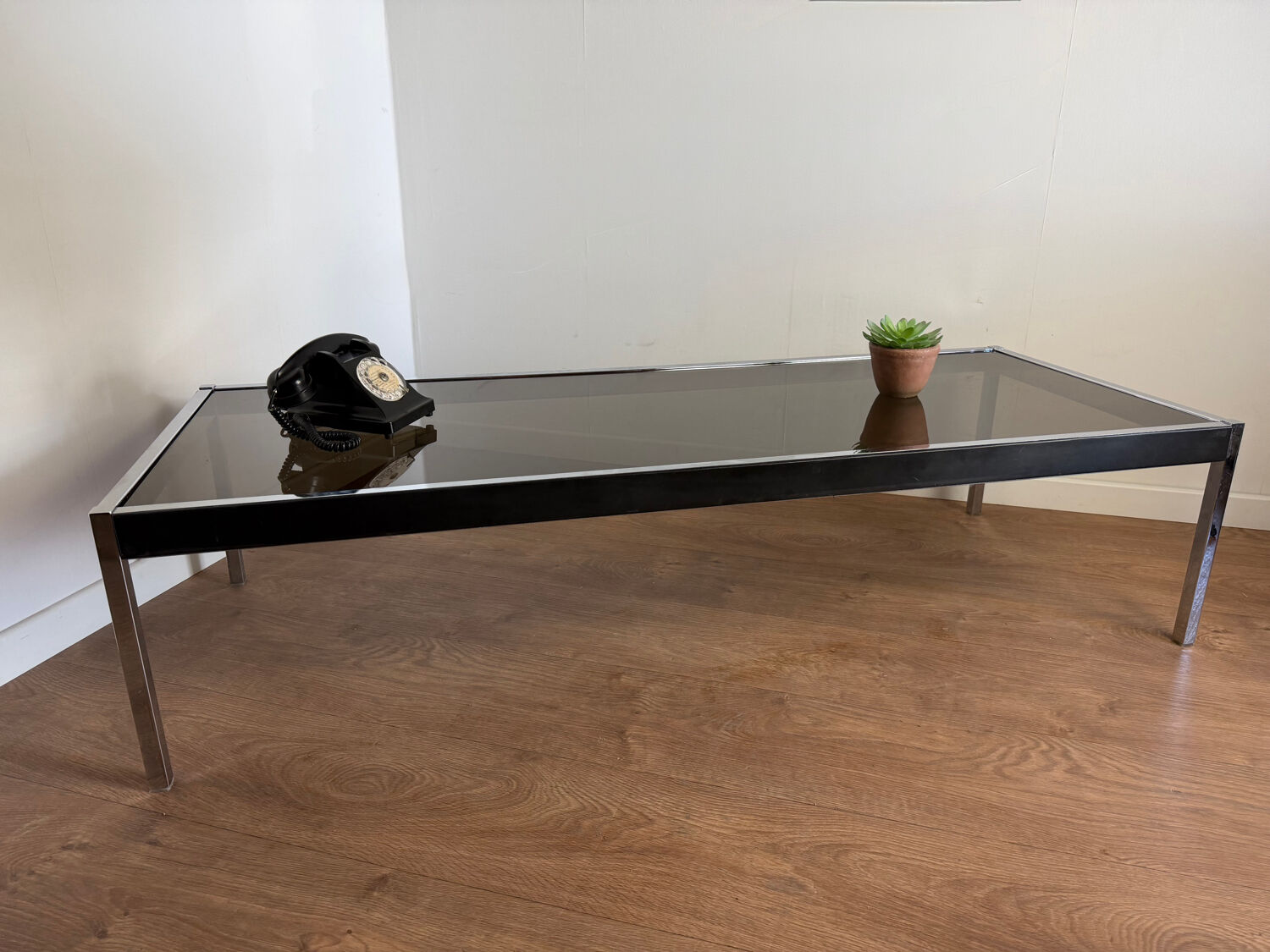 Large designer coffee table from the 70s in chrome, smoked glass, and faux leather.