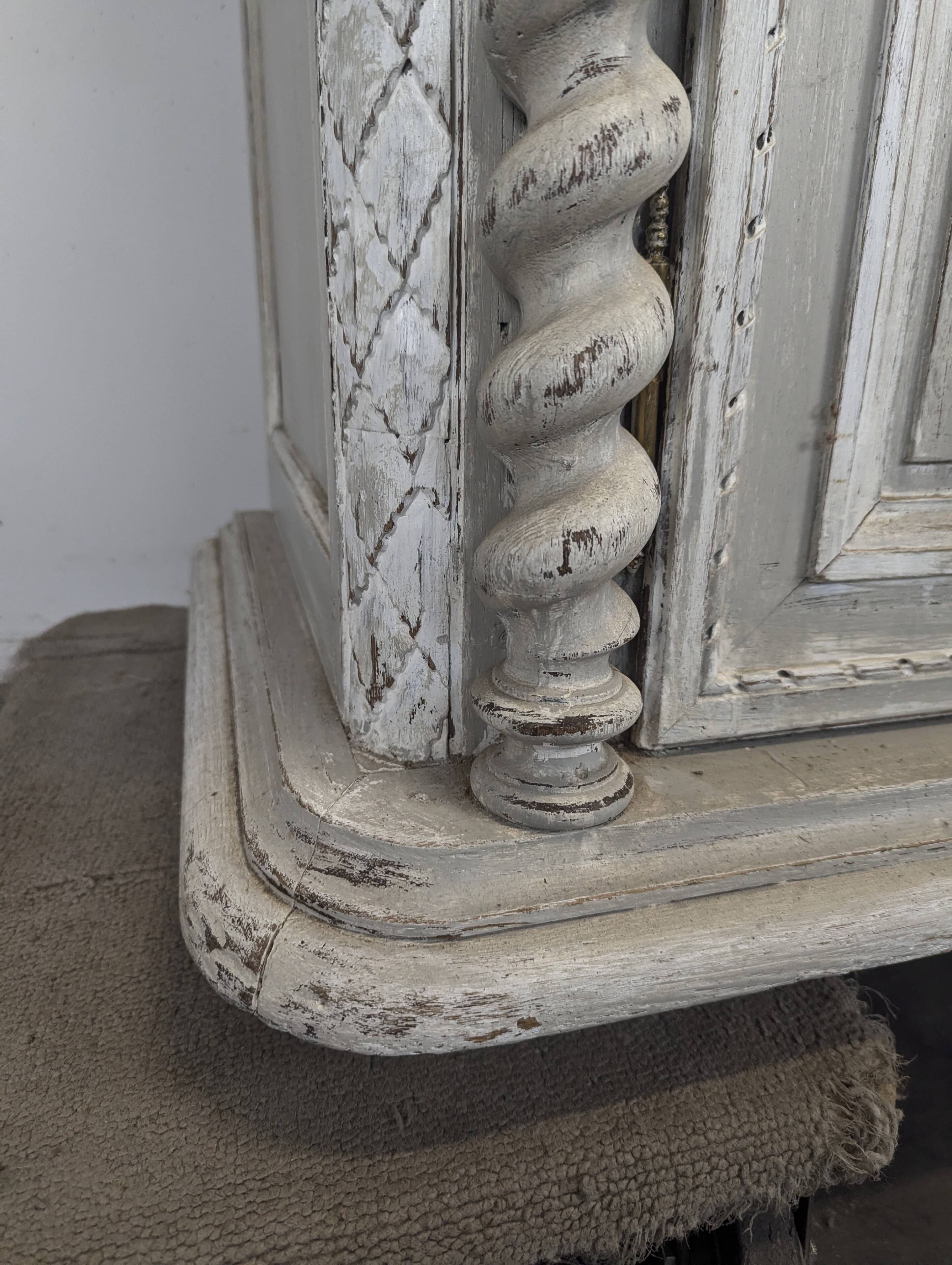 Louis XIII buffet with twisted column in grey patinated oak, two doors, two drawers.