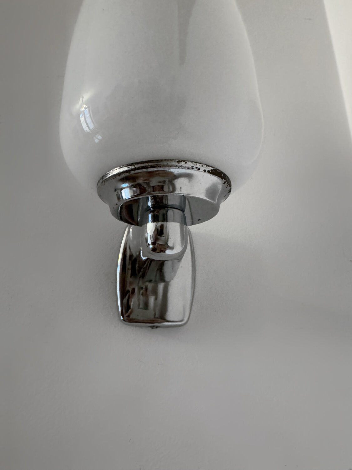 Chrome and opaline wall lights from the 70s.