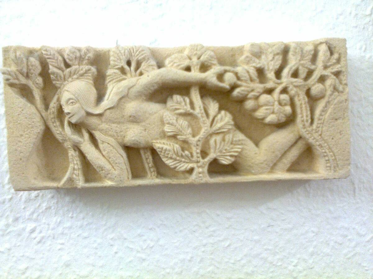 Sculpted stone wall decoration, medieval motif: Eve in the Garden of Eden