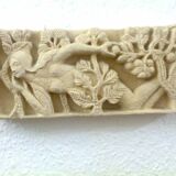 Sculpted stone wall decoration, medieval motif: Eve in the Garden of Eden