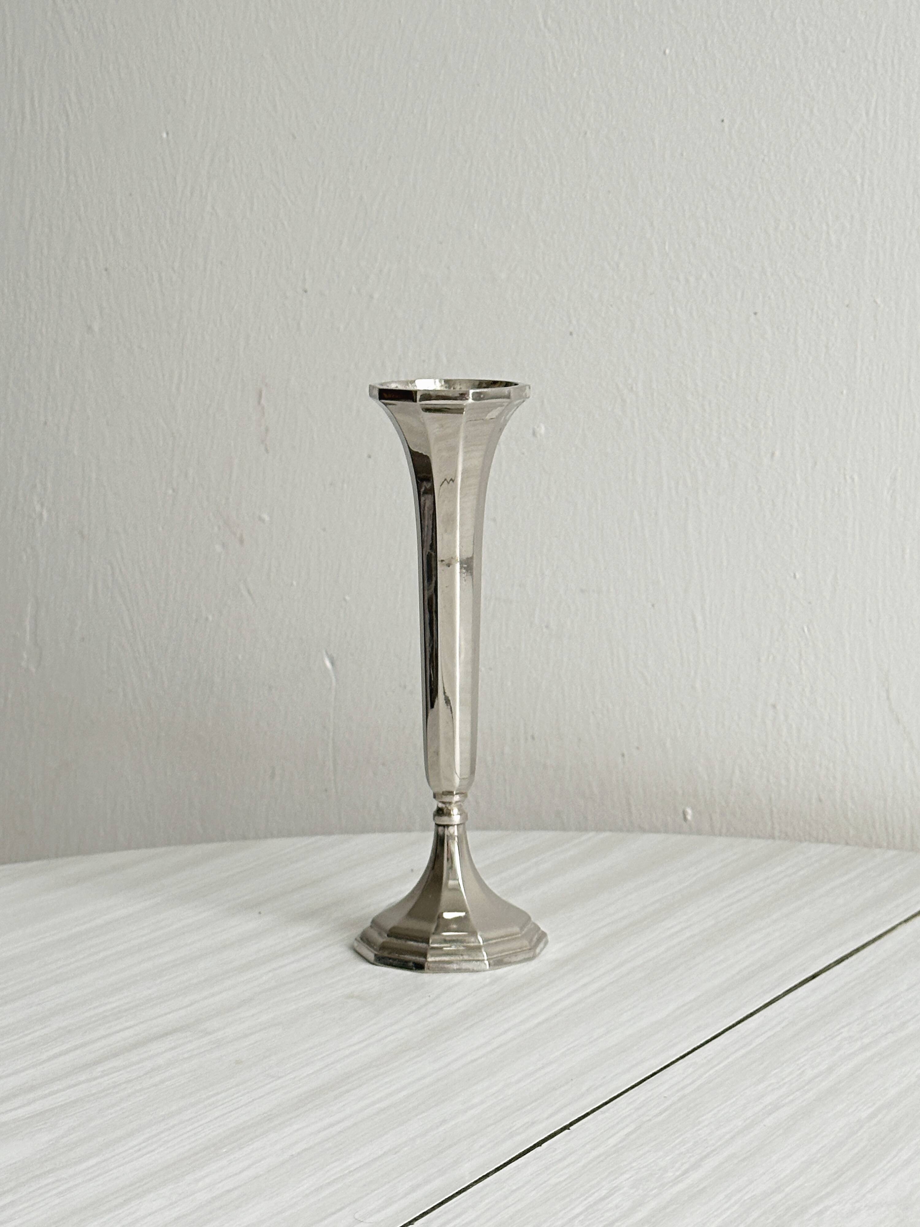 single flower vase or metal candlestick