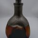 Vintage decanter in glass and tin.
