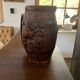 Hungarian folk ceramic pitcher with a brown glossy finish and relief decoration of vine.