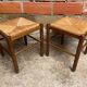 Pair of vintage wooden stools with woven straw seats