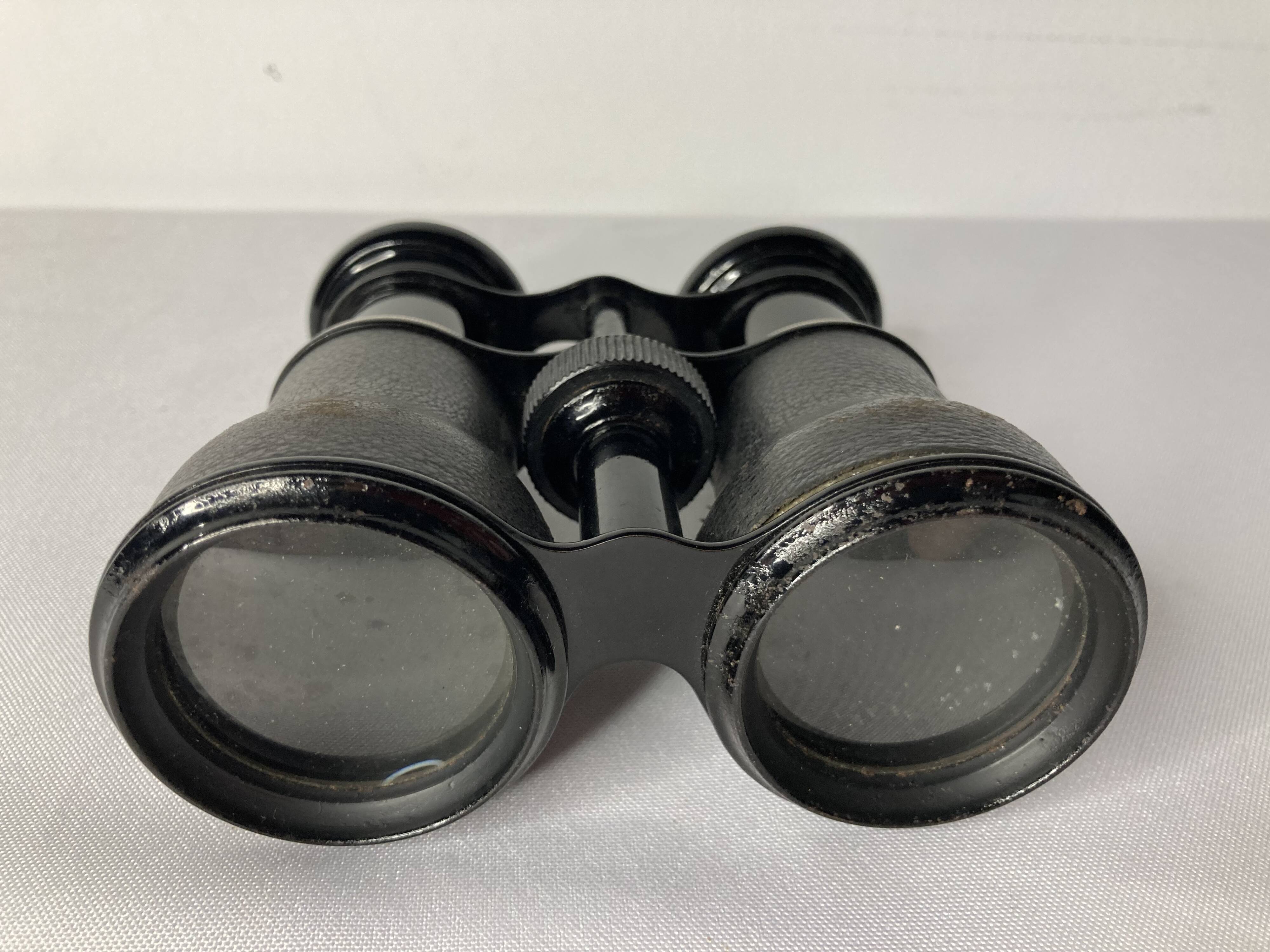 Old pair of binoculars sheathed leather black silver metal